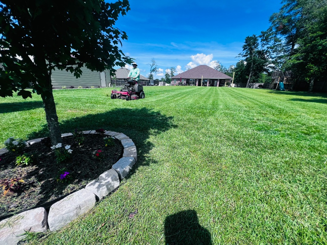 Prepping For New Sod? Tips & Pointers - ProMow Lawn & Landscaping A ProMow professional taking care of a lawn mowing job.
