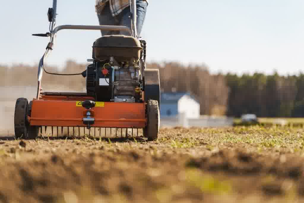 An expert pushing an aeration machine.
