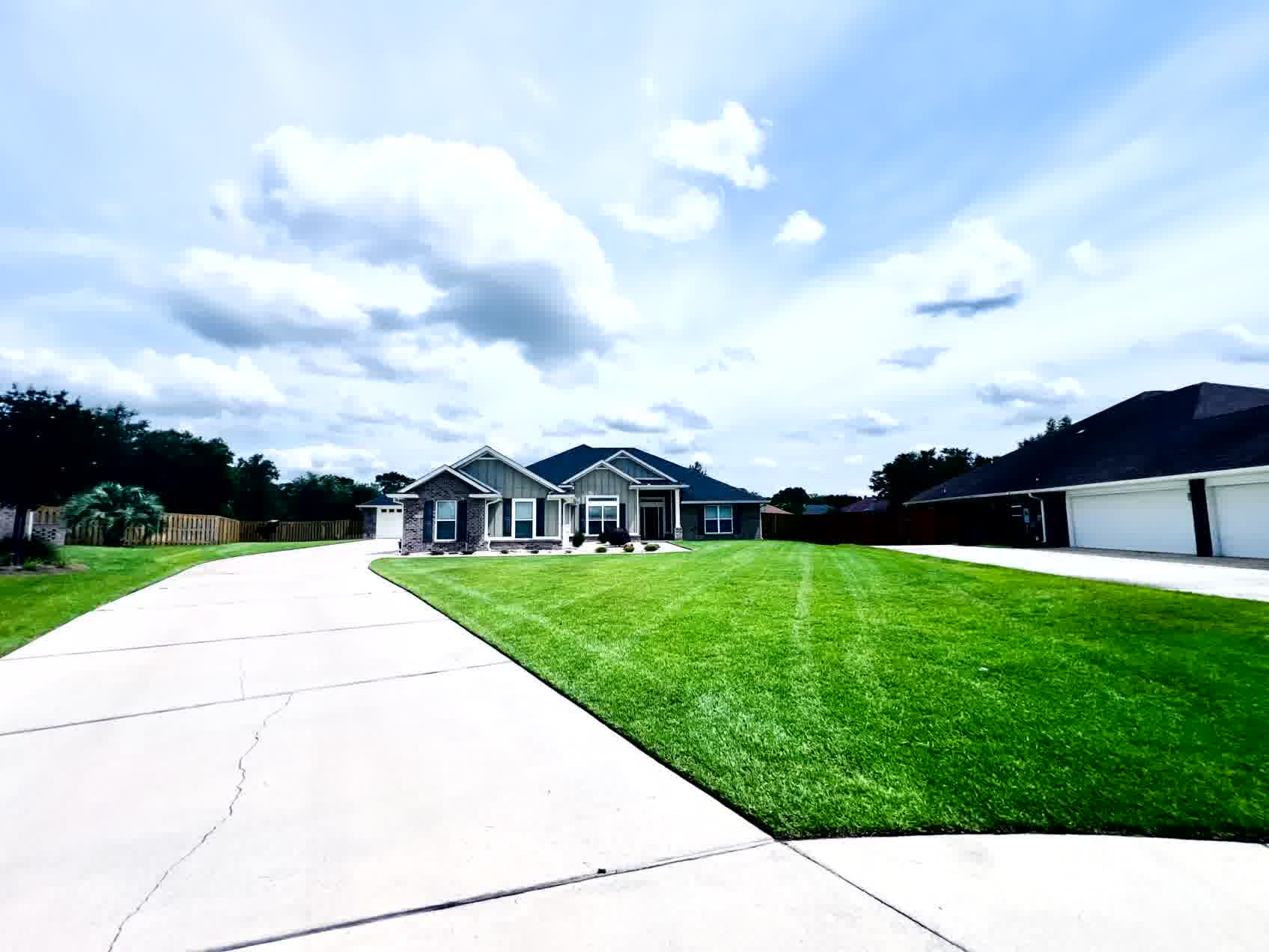 The Secret to a Lush Lawn All Year Long - ProMow Lawn & Landscaping A vibrant, healthy lawn that receives regular professional maintenance and care.